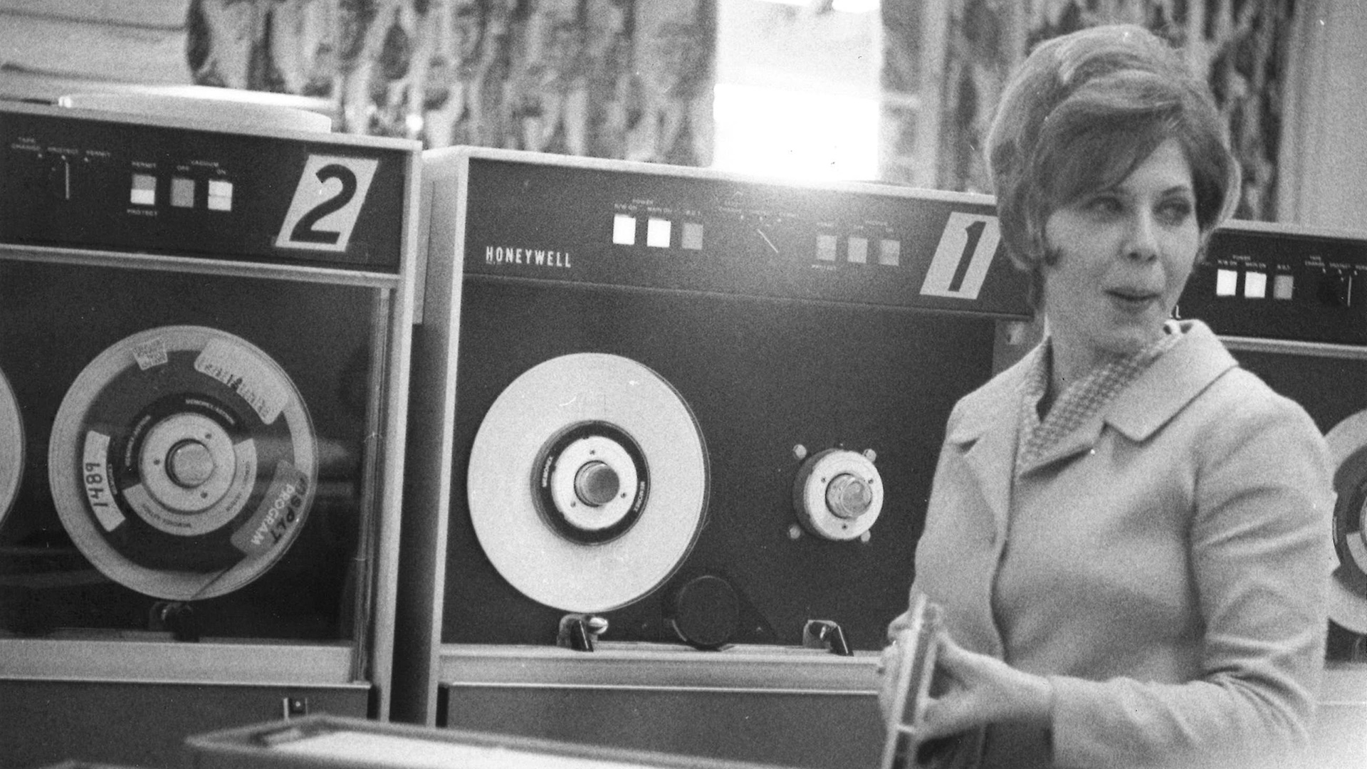 An STRS Ohio associate in the 1960s stands in front of recording equipment.