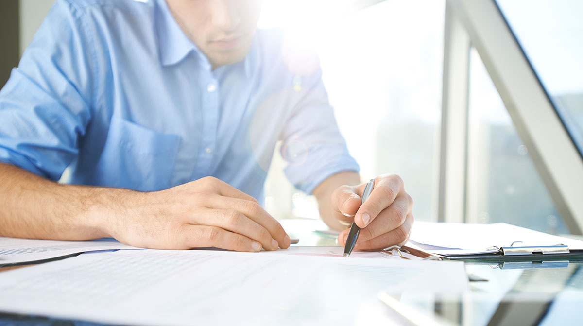 Photo of a man writing.