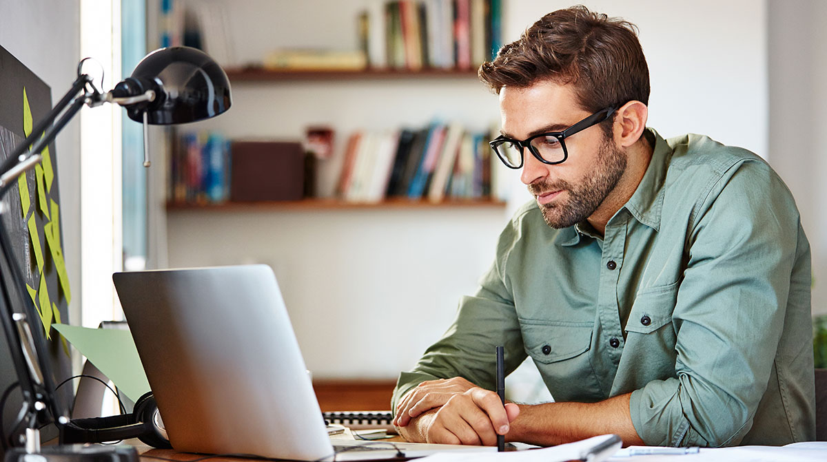 Photo of a man using a laptop.