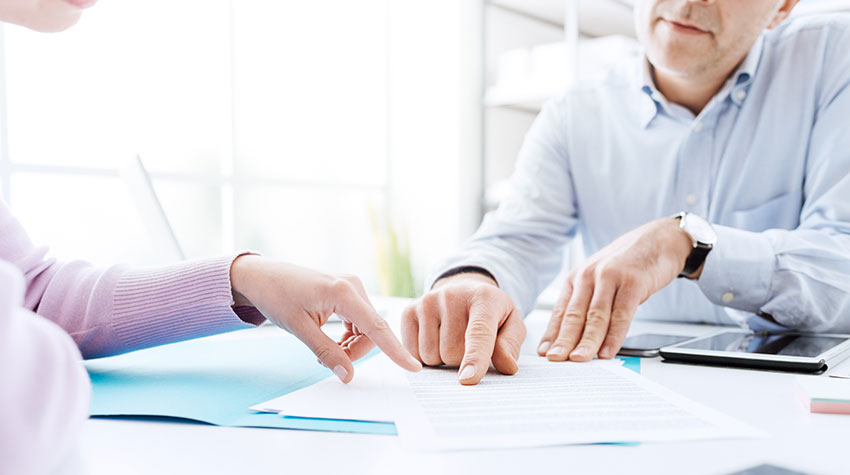 Photo of people going over paperwork.