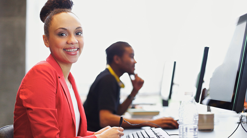 Photo of a woman at a desk.